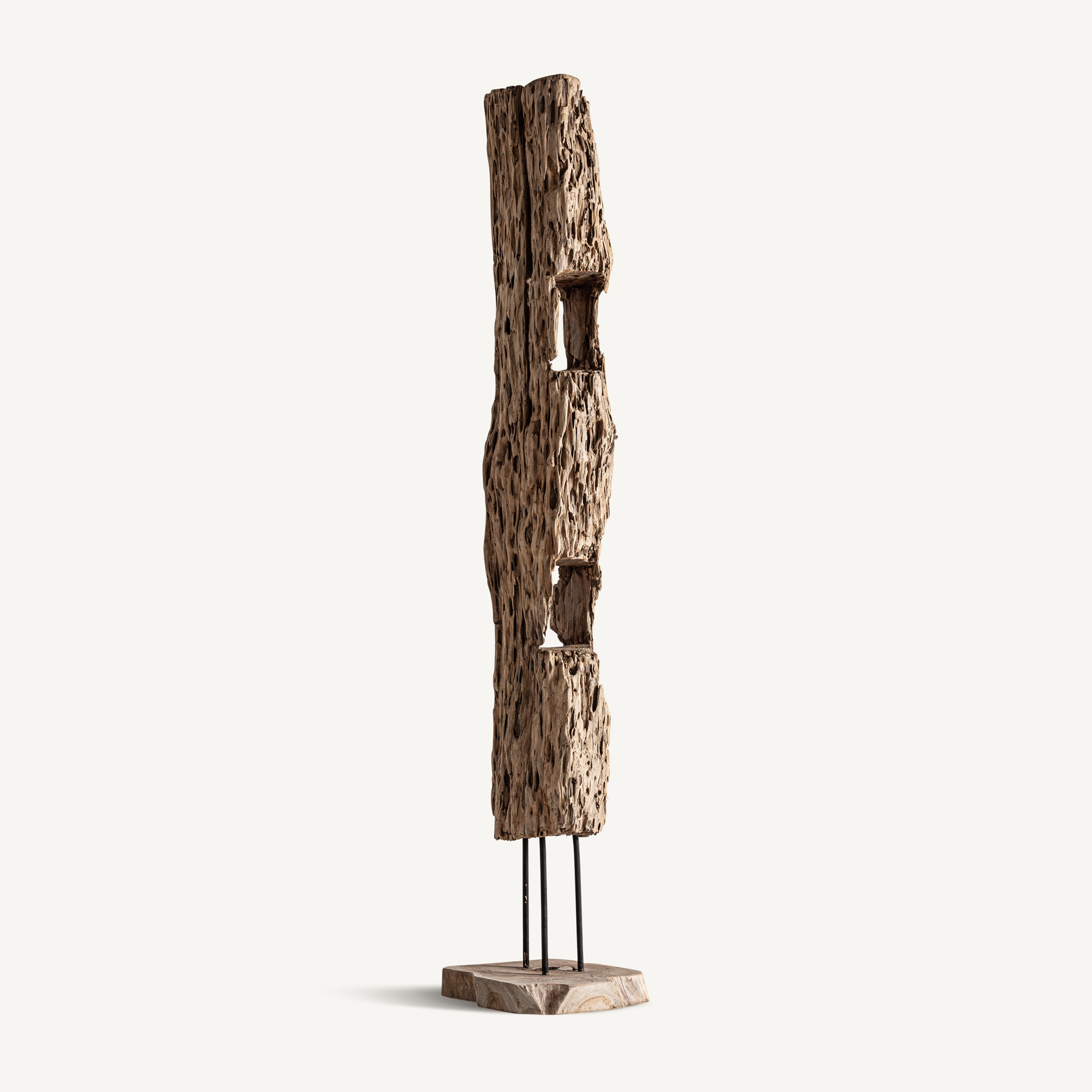 Tall textured reclaimed-wood sculpture with two openings, raised on dark supports above a square base